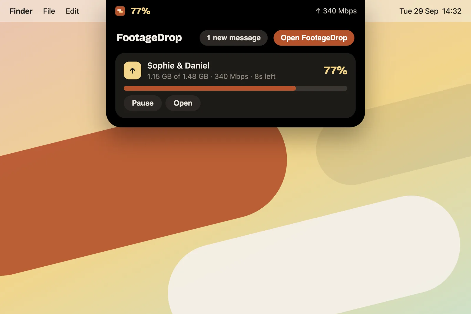 The FootageDrop pill by the notch, open to show an upload with Pause